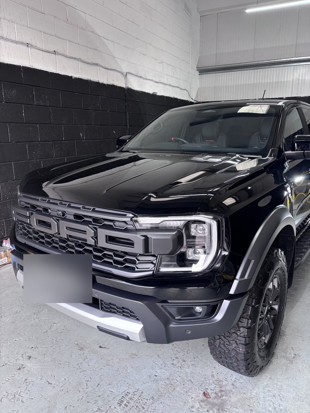 Close-up of the coated bonnet and grille of a Ford Ranger Raptor