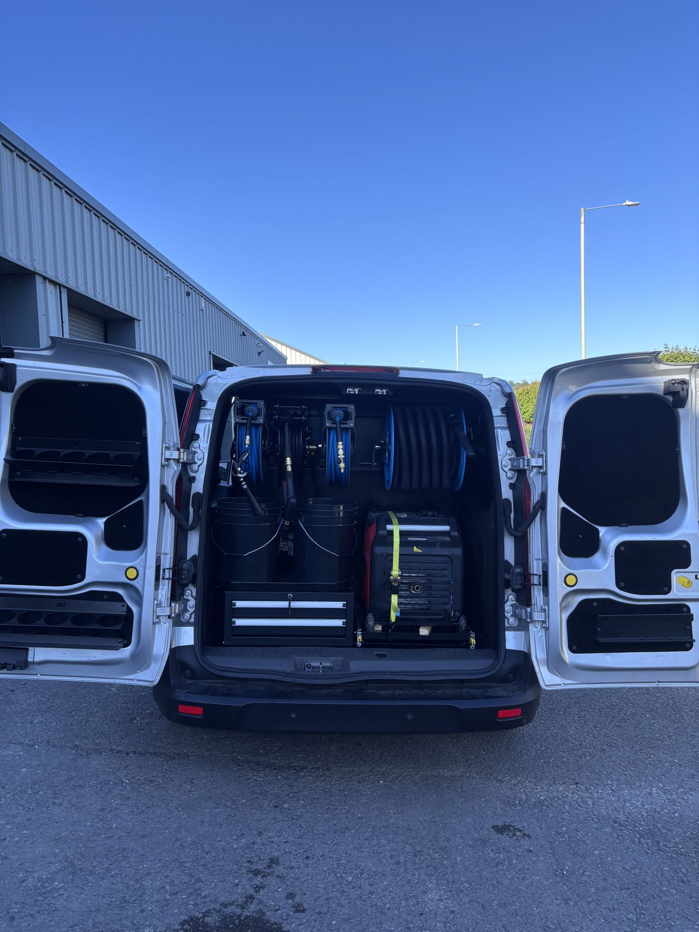 Fully kitted-out mobile detailing van with hose reels, buckets and generator